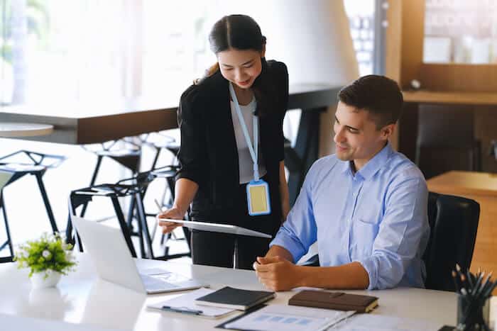 Employee showing a tablet to her boss