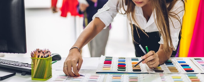 Sports equipment manufacturer: designer looking at fabric swatches