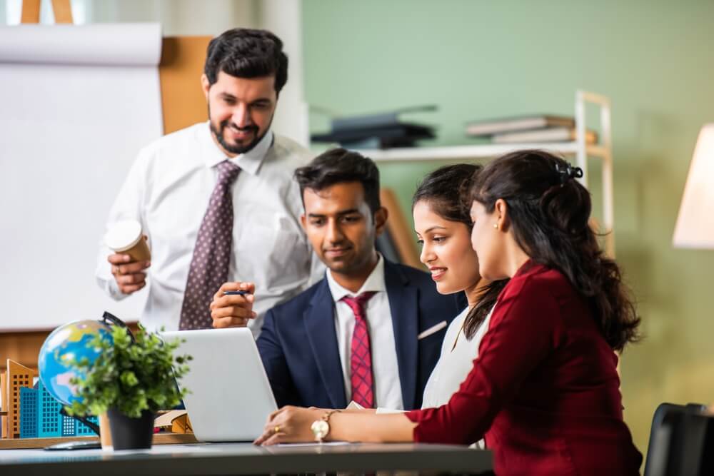 Indian business professionals talking in a meeting about supply chains.