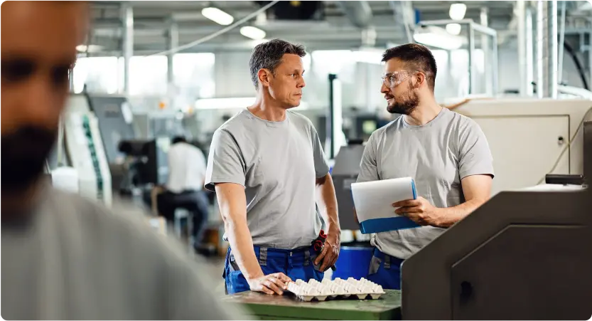 Manufacturers talking to each other in the factory.